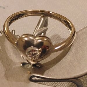 18K white gold and diamond heart-shaped ring.  Currently size 4.5 can be made